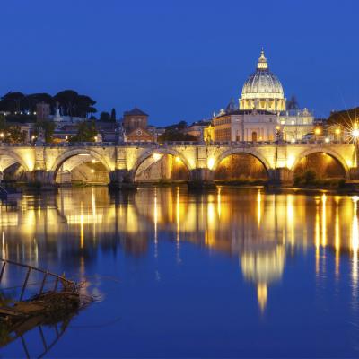 Saint Angel Bridge And Saint Peter Cathedral With A Mirror Reflection In The Tiber River During Morning Blue Hour In Rome Italy